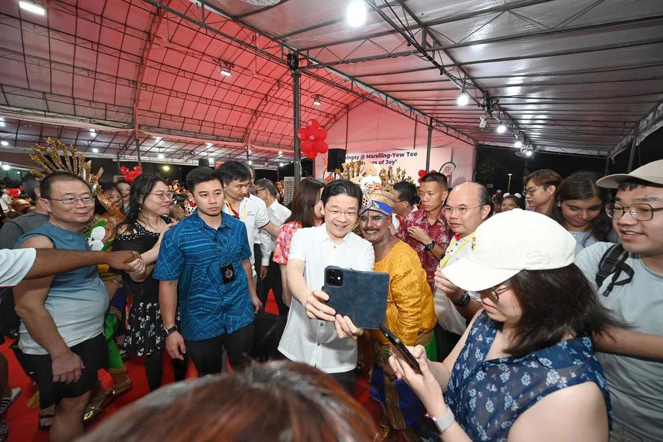 PM Wong taking pictures with residents at the Chingay@Heartlands celebration on Feb 22.