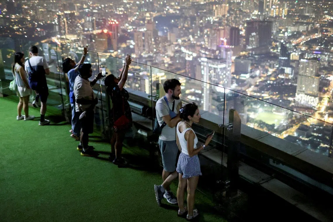 Visitors to the KL Tower look at the scenery of Kuala Lumpur city centre at Kuala Lumpur, Malaysia March 25, 2026. REUTERS/Hasnoor Hussain