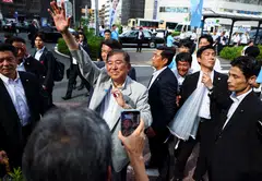 By removing the uncertainty around tariffs, Ishiba (centre, in grey) will finally have done some good for the country.
But he will leave Japan in a weaker position than when he took office.
