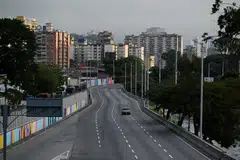 A car drives on an empty street, after US President Donald Trump said the US has struck Venezuela and captured its President Nicolas Maduro, in Caracas, Venezuela on Jan 3.