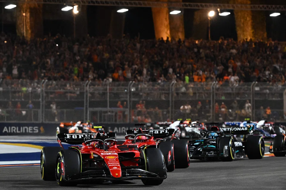 Ferrari's Spanish driver Carlos Sainz Jr (left) drives during the Singapore Formula One Grand Prix night race at the Marina Bay Street Circuit in Singapore on Sep 17, 2023.