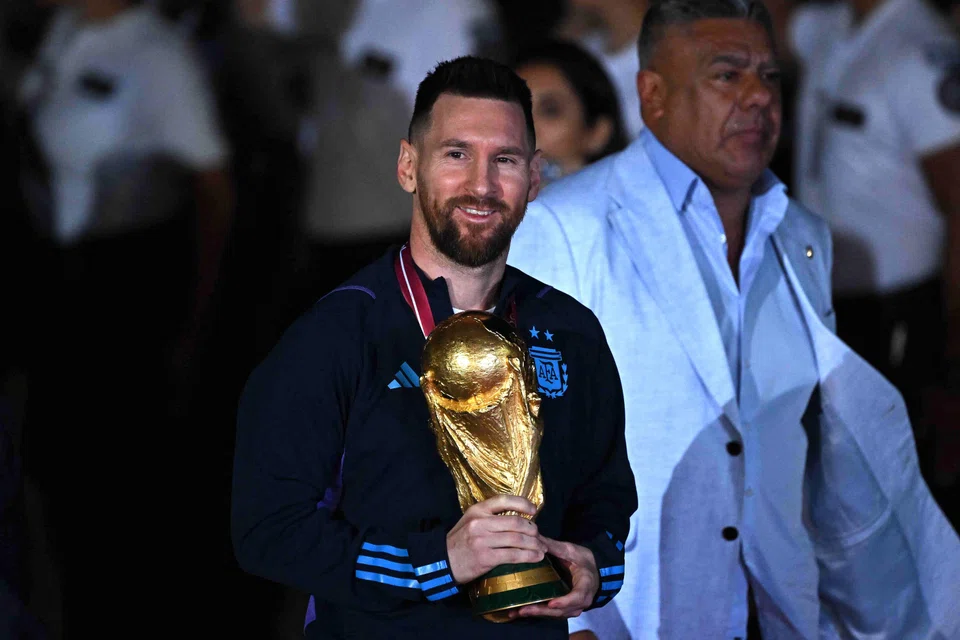 Argentina's captain Lionel Messi holds the Fifa World Cup trophy upon arrival at Buenos Aires' Ezeiza International Airport on Dec 20.