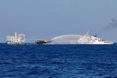 Chinese Coast Guard vessels fire water cannons towards a Philippine resupply vessel on its way to a resupply mission at Second Thomas Shoal in the South China Sea, March 4, 2024. Tensions over the strategic waterway, a key passage for sea-borne trade, have soared in the past 18 months following a series of escalating confrontations between Philippine and Chinese ships.