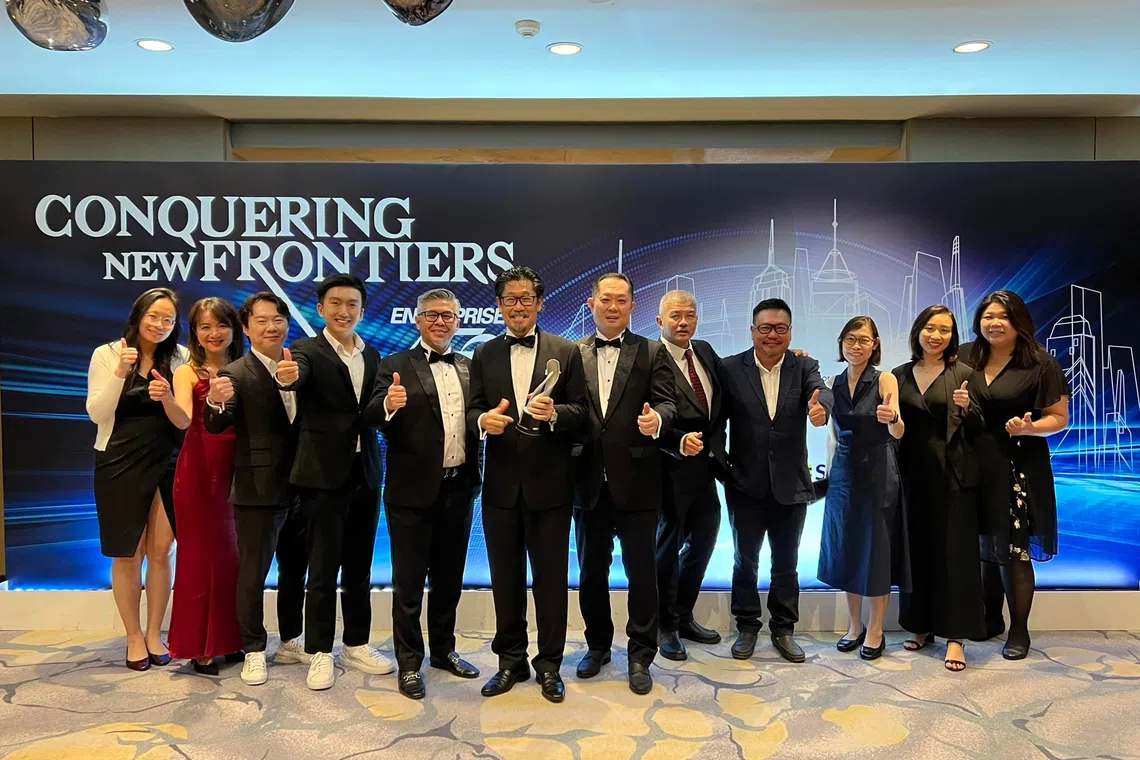 Management and staff of JGL Worldwide at the Enterprise 50 awards ceremony in 2023. Among them are chief executive officer Daniel Lim, chairman Desmond Gay and chief operating officer David Hia (fifth to seventh from left).
