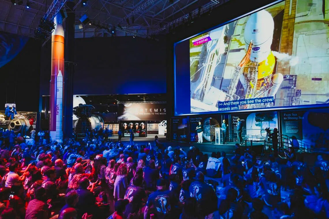 A crowd gathered at the museum Space Center Houston watching the live launching of Artemis II for its moon mission via a large screen, in Houston on Apr 1.  
