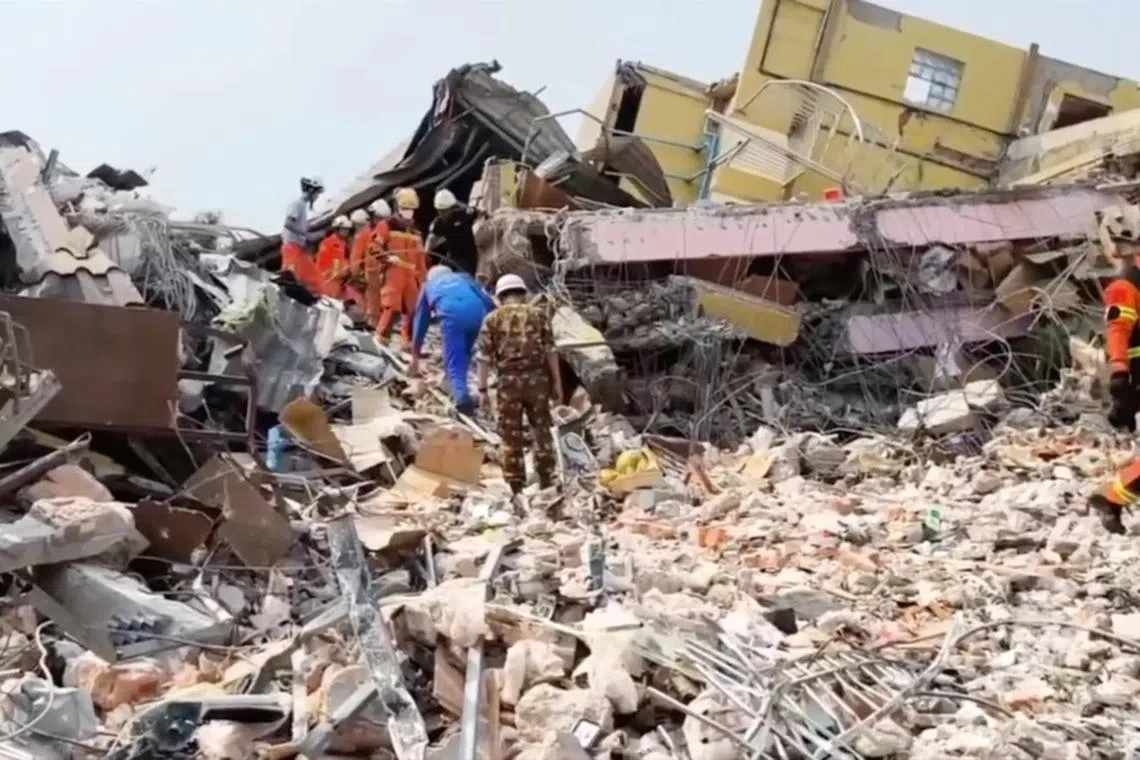 Specialists, including members of Russia's emergencies ministry, take part in a search operation following a massive earthquake in Mandalay, Myanmar, April 1, 2025. 