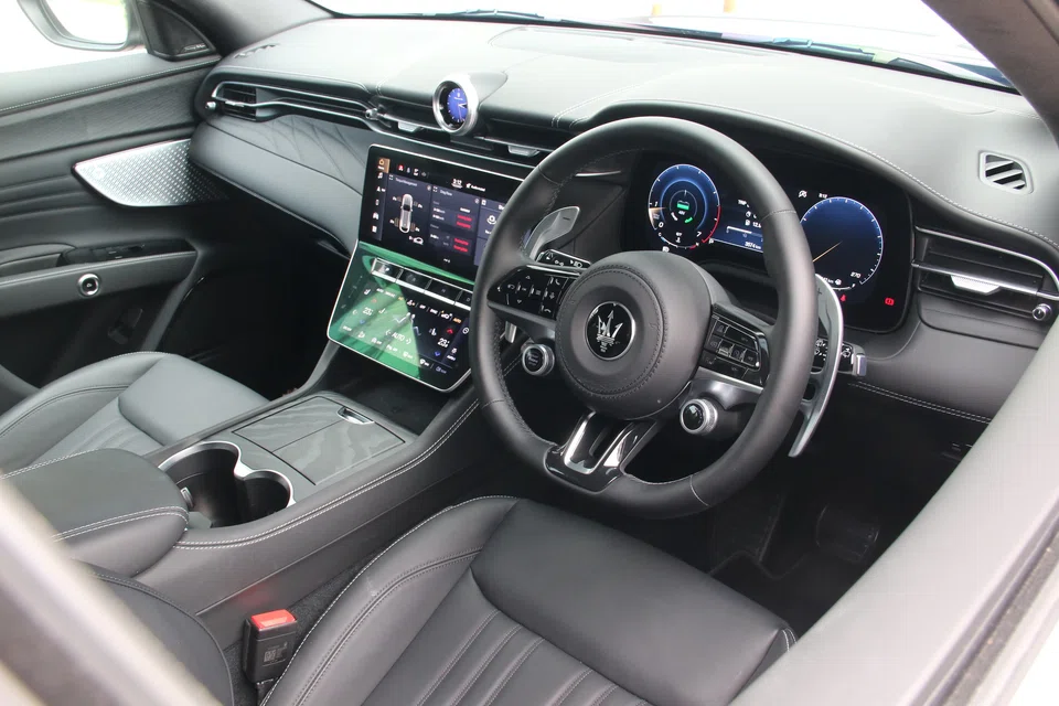 The dashboard has a main touchscreen, with a second screen below it for the climate system and other controls.
