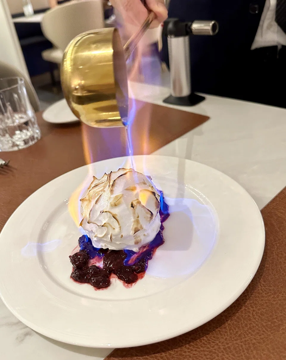 Baked Alaska is flambeed at the table.