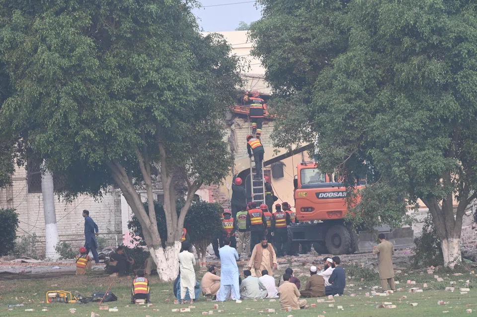 Rescue workers work at the site of an Indian missile strike near Muridke, Punjab province, Pakistan, May 7, 2025. The Indian government said it conducted military strikes on nine sites in Pakistan in retaliation for a deadly militant attack on tourists in Kashmir.