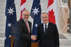 (From left) Australian Prime Minister Anthony Albanese shakes hands with Canada's Prime Minister Mark Carney at the Australian Parliament House, Canberra, Australia, March 5, 2026.