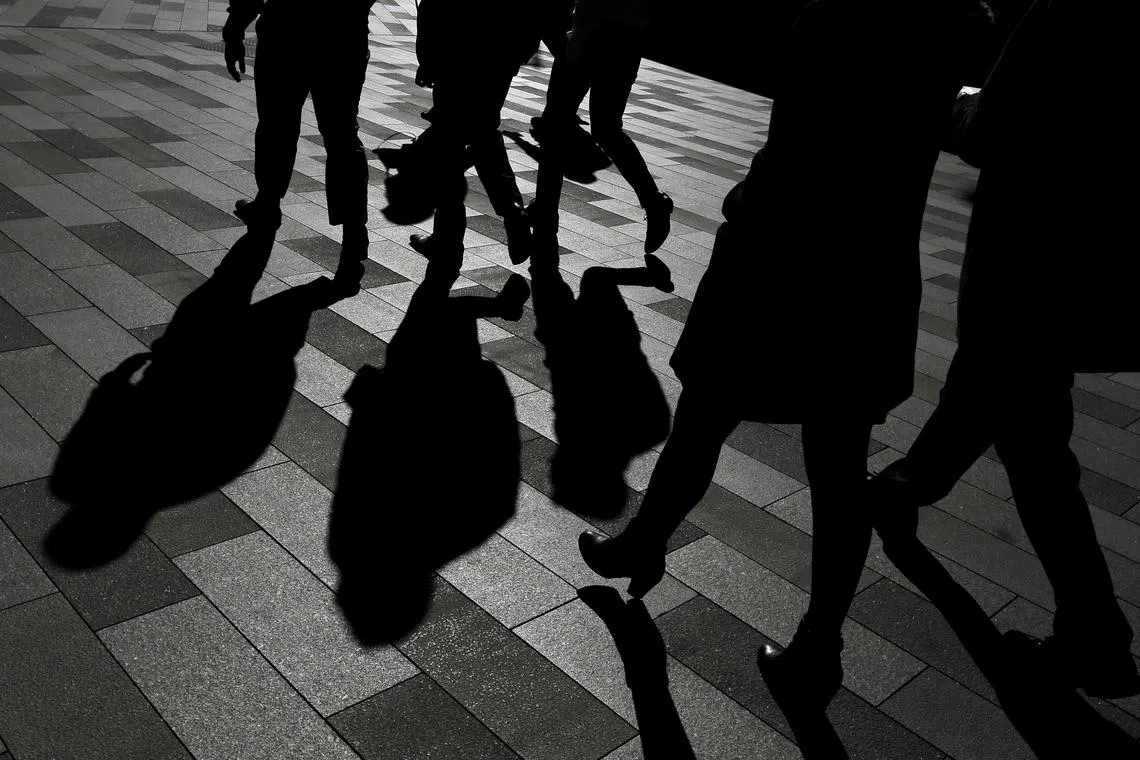 Workers cast shadows as they stroll among the office towers Sydney's Barangaroo business district in Australia's largest city, May 8, 2017. REUTERS/Jason Reed