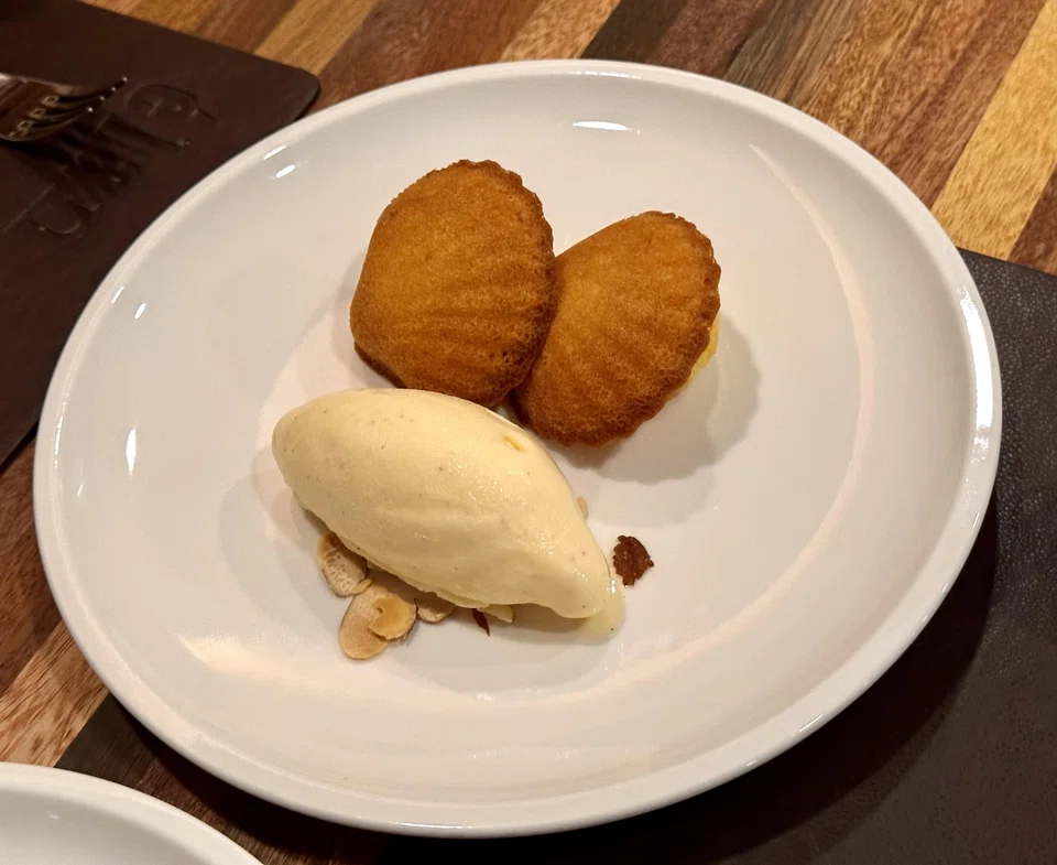 Fluffy warm madeleines served with ice cream.