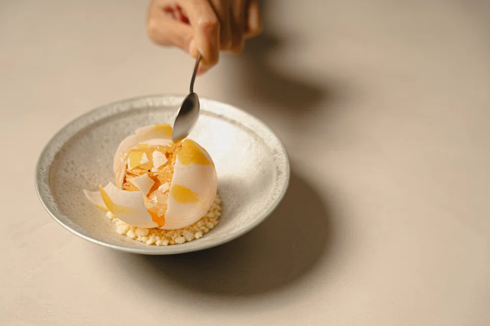 Citrus snowball filled with kueh ambon cubes and candied orange.