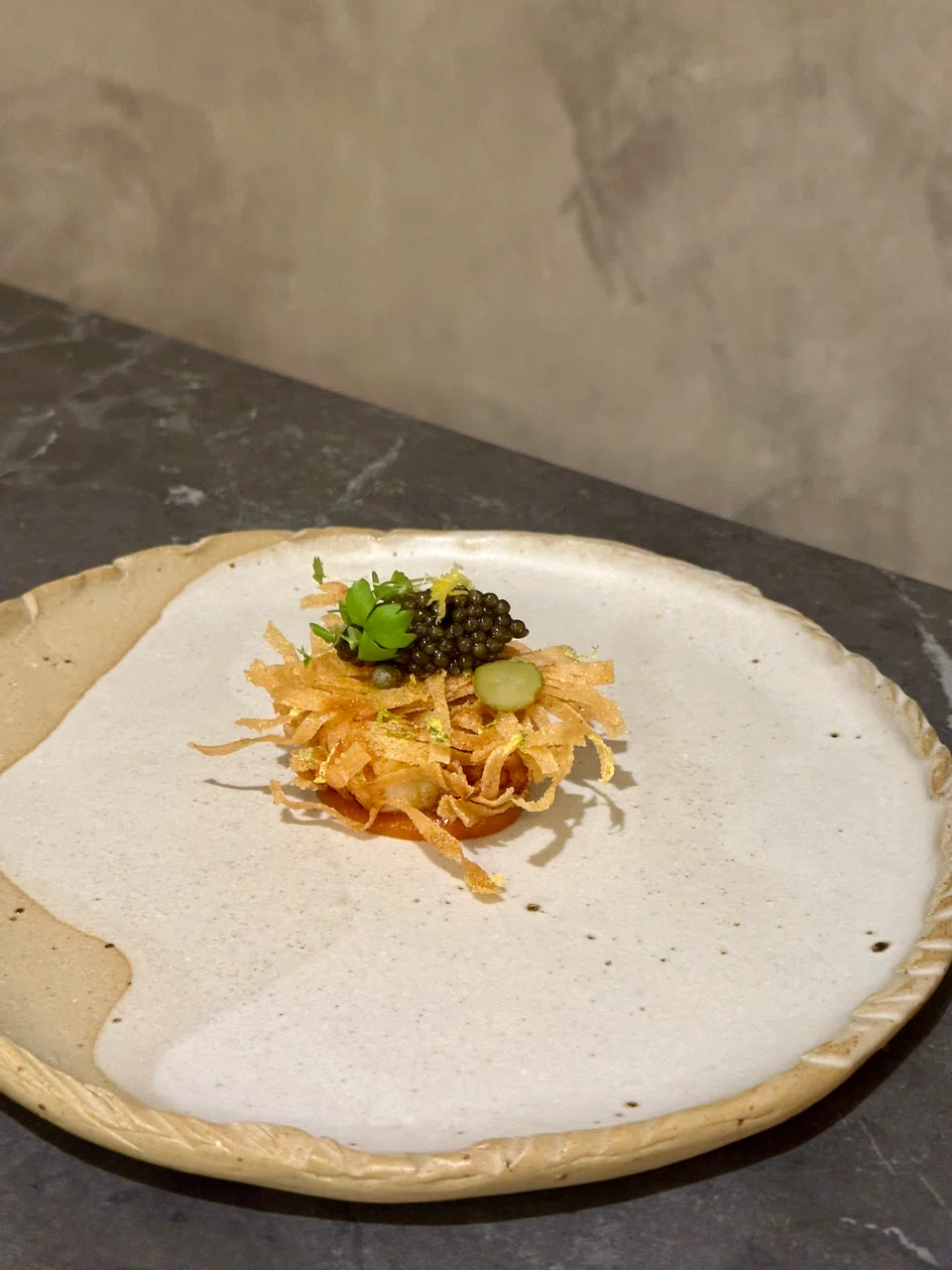 Crunchy pasta nest atop a bouncy prawn ball with caviar garnish.