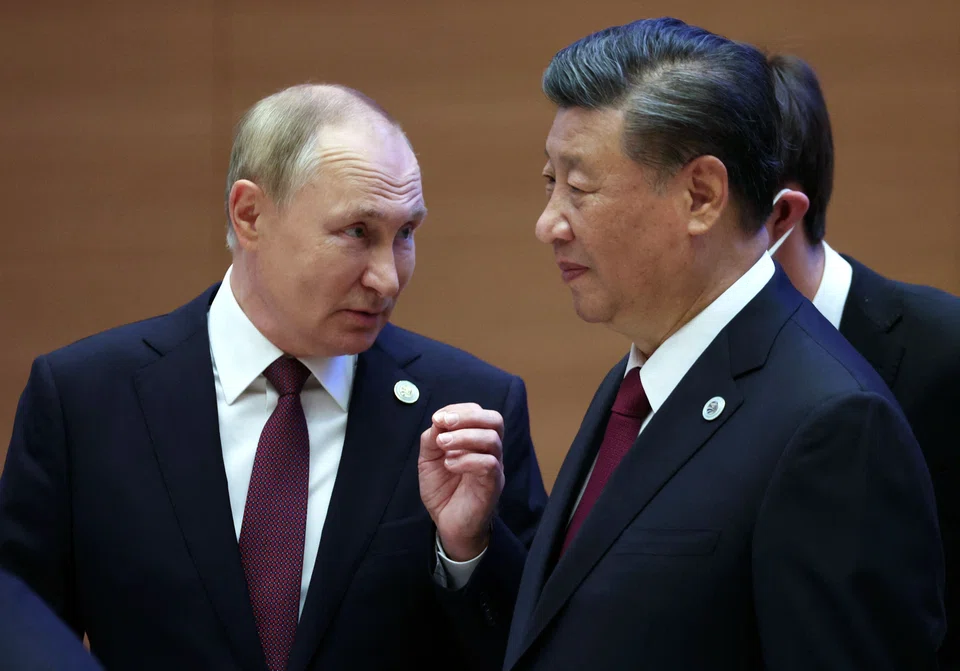 Russian President Vladimir Putin speaks to China's President Xi Jinping during the Shanghai Cooperation Organisation leaders' summit in Samarkand on Sep 16, 2022. 