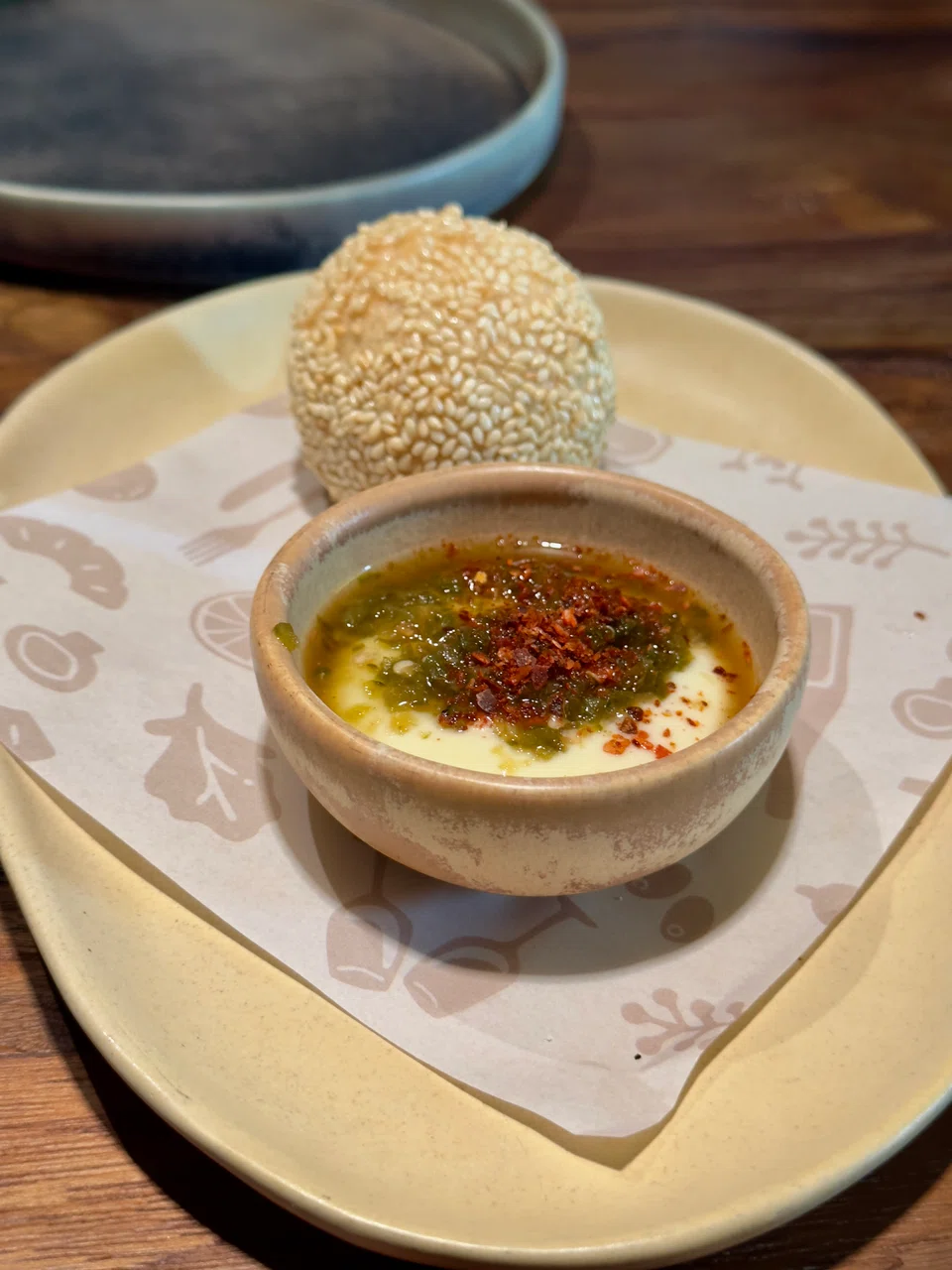A Chinese style glutinous rice ball is filled with a spicy pork mixture, with aioli on the side.