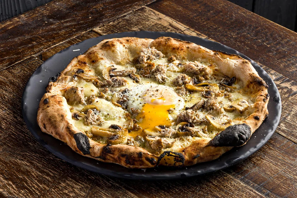 Bismarck pizza features cheese, pork sausage and soft-cooked egg.