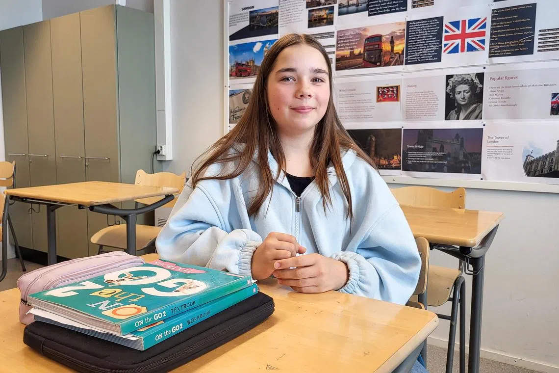Eight-grader Inka Warro, 14, sits near her English language books at Pohjolanrinne middle school in Finland.