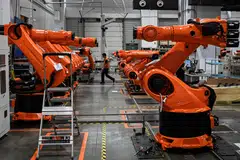 Robotic arms made by industrial robot manufacturer KUKA at its factory owned by Chinese home appliances giant Midea Group in Foshan, in China's southern Guangdong province, in July 2022. 