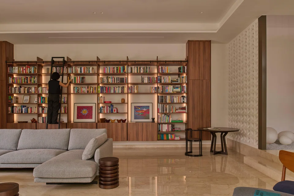 A custom-built, double-volume bookshelf is a centrepiece in the home.