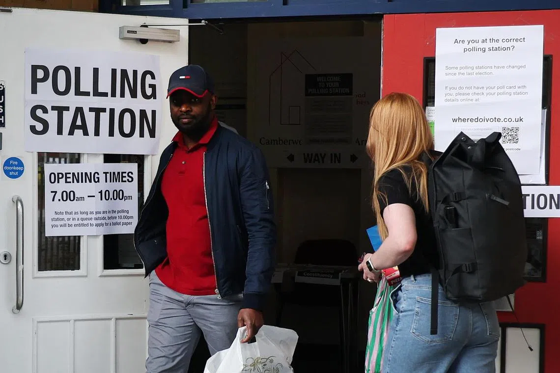 Voters exit a polling station in London. In what was billed as a pivotal moment for the country, 40 per cent of the electorate did not bother to exercise their right to choose an MP or government.