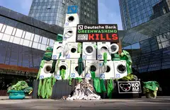Activists stack washing machines in front of the Deutsche Bank headquarters to protest against greenwashing during the bank's annual shareholders meeting in Frankfurt, Germany, on May 19, 2022.     
