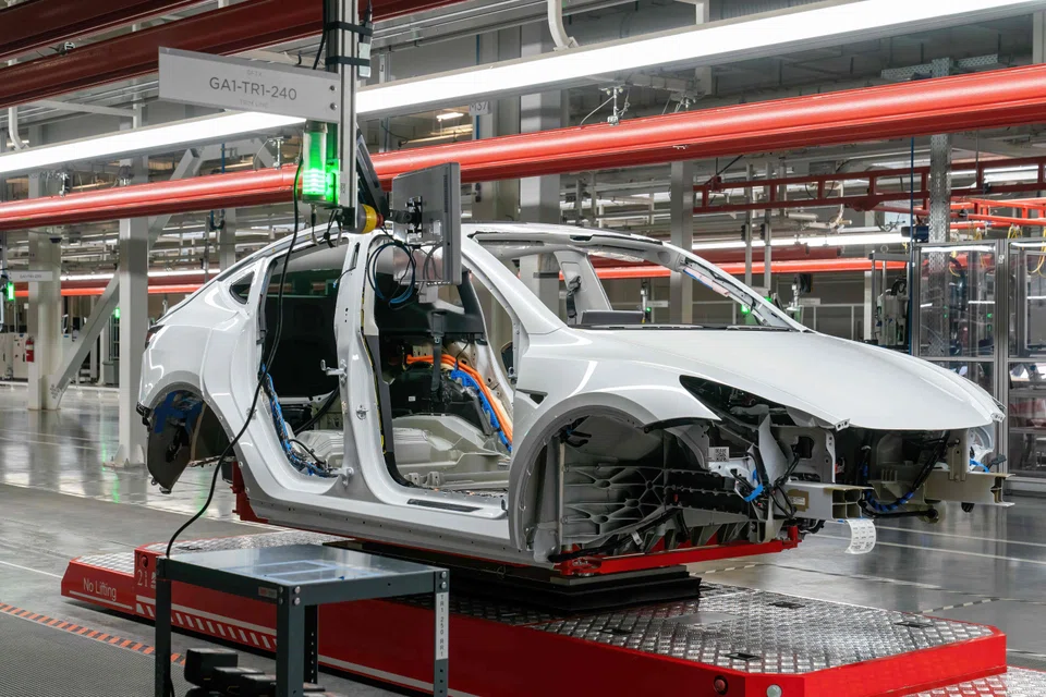 Cars are seen on the assembly line during a tour of the Tesla Giga Texas manufacturing facility ahead of the "Cyber Rodeo" grand opening party on April 7, 2022 in Austin, Texas. S&P Global’s final manufacturing Purchasing Managers’ Index (PMI) fell to 52.1 in June from May’s 54.6, its lowest since August 2020.