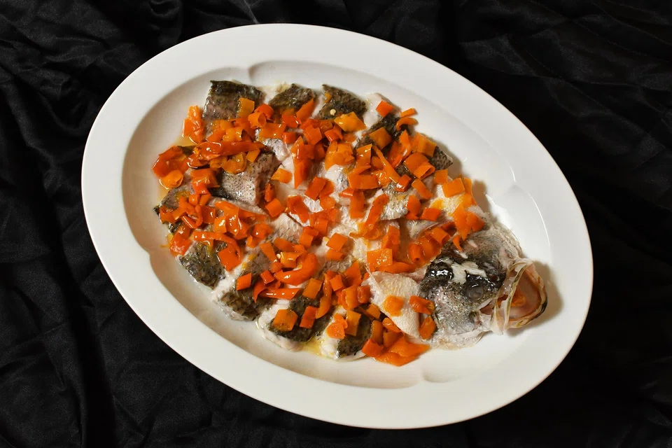 Steamed yellow croaker with pickled chillies.