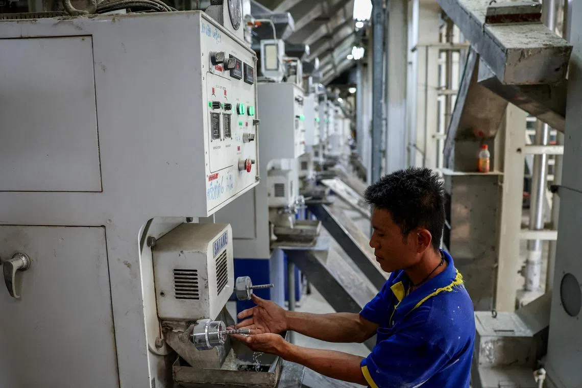 A Thai worker at a rice mill.  US tariffs have impacted key sectors across South-East Asia, including Thailand's agricultural products.