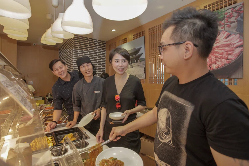 Lena Sim (second from right), has been declared bankrupt following a suit against her over a loan for US$5 million. 