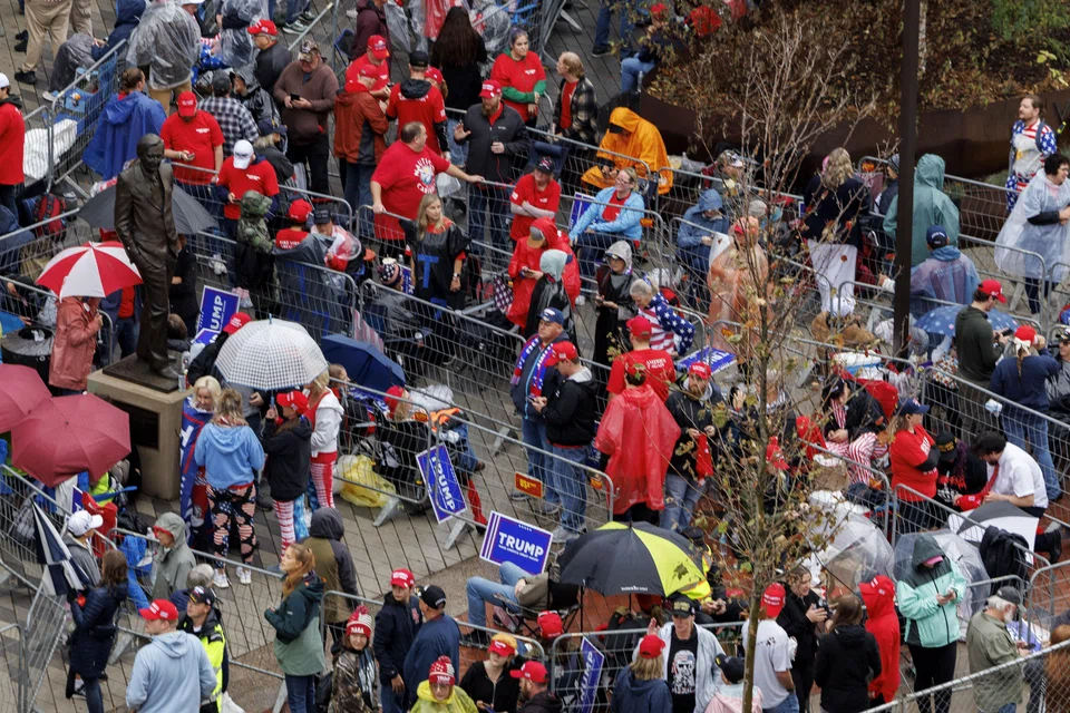 Supporters of former US President Donald Trump gather outside the venue of a planned campaign rally in Grand Rapids, Michigan, Nov 4, 2024. 