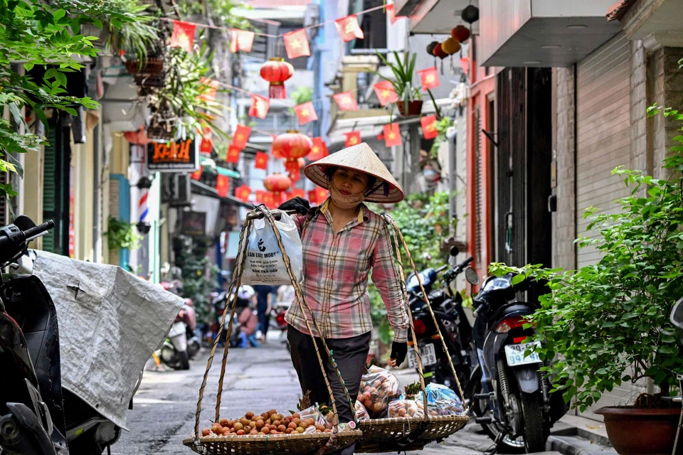 A street vendor in Hanoi, Vietnam. The country is the only economy that saw an improvement in its 2025 growth forecast to 7% from Amro's earlier April forecast of 6.5%.