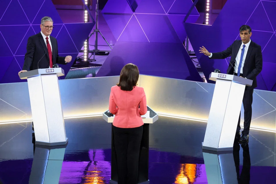 (Left) Labour Party leader Keir Starmer and Britain's Prime Minister and Conservative Party leader Rishi Sunak (right) spar during a live debate in Nottingham, Britain, June 26, 2024.