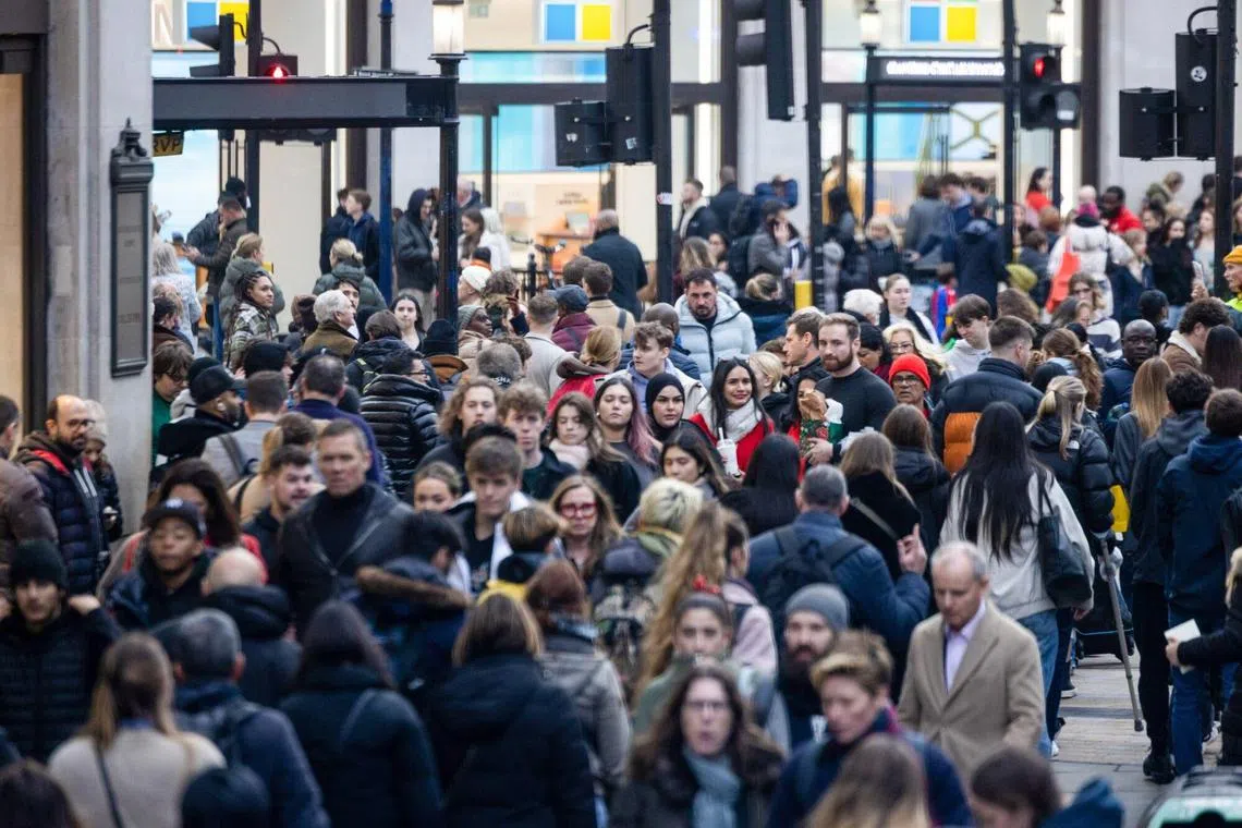 Crowds of shoppers on Oxford Street in London, UK, on Dec 18, 2023. In the final days of the year, the stress from looking back on financial choices begins to collide with that linked to planning ahead.