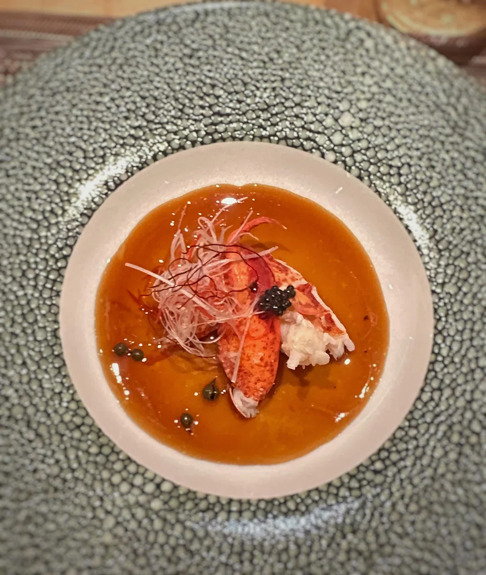 Steamed lobster in peppercorn-infused sauce.