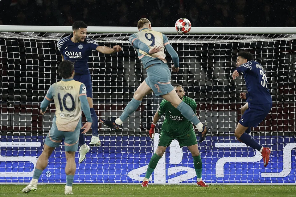 Manchester City striker Erling Haaland (wearing the No 9 jersey) heading the ball in his team's Champions League match against PSG on Wednesday. City lost 4-2 after leading 2-0.