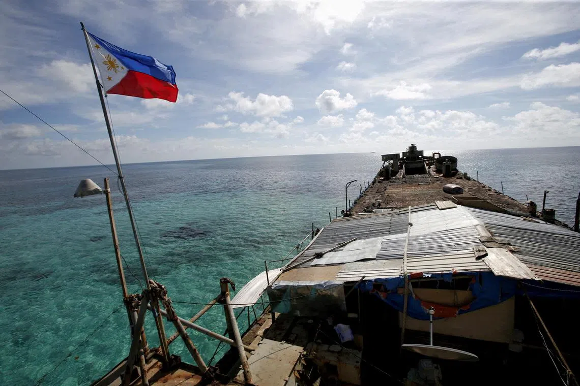A Philippine flag flutters from a dilapidated Philippine Navy ship that has been aground since 1999 and became a Philippine military detachment on the disputed Second Thomas Shoal, part of the Spratly Islands, in the South China Sea. 