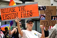 People holds signs calling for the release of files regarding late sex offender Jeffrey Epstein at a protest in Houston, Texas, July 17, 2025.