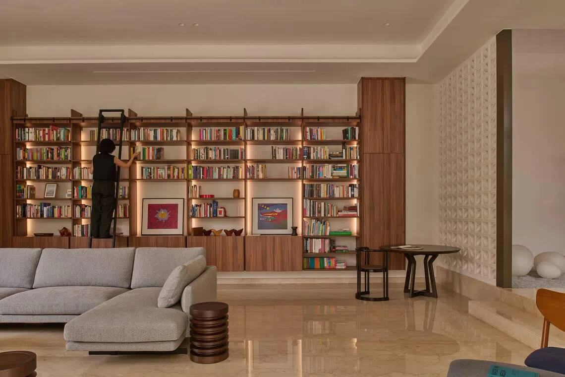 A custom-built, double-volume bookshelf is a centrepiece in the home.