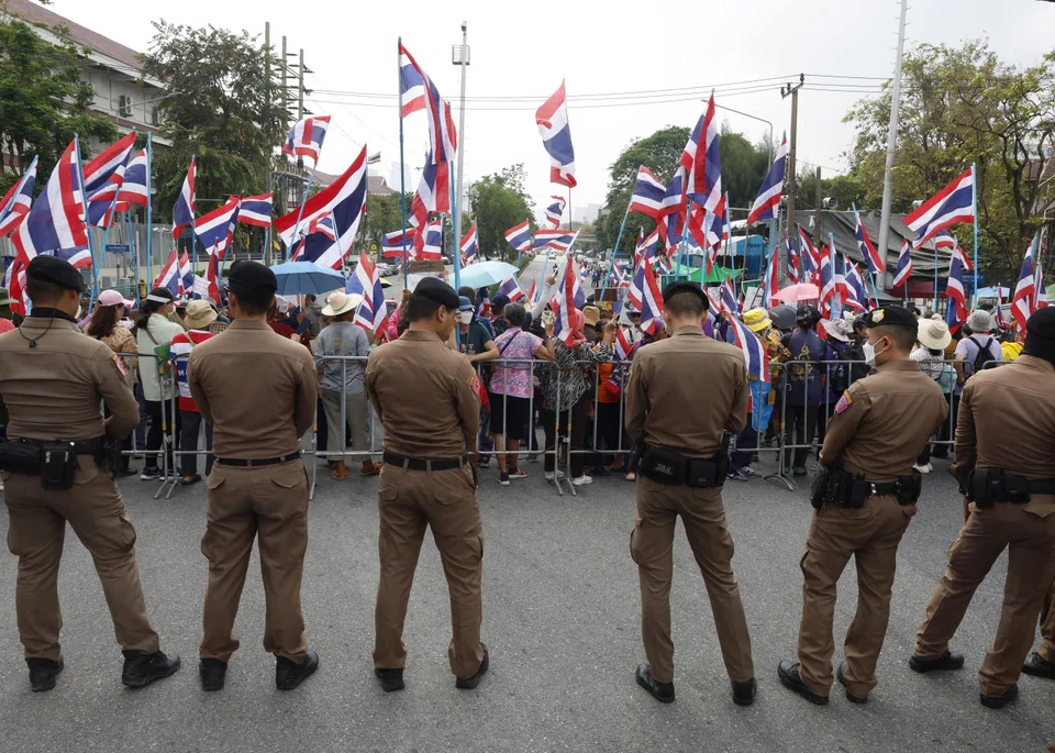 Police officers stand guard as anti-casino protesters protest the government's draft of an entertainment complex bill to legalise casino gambling outside the Government House in Bangkok, Thailand, March 27, 2025. 