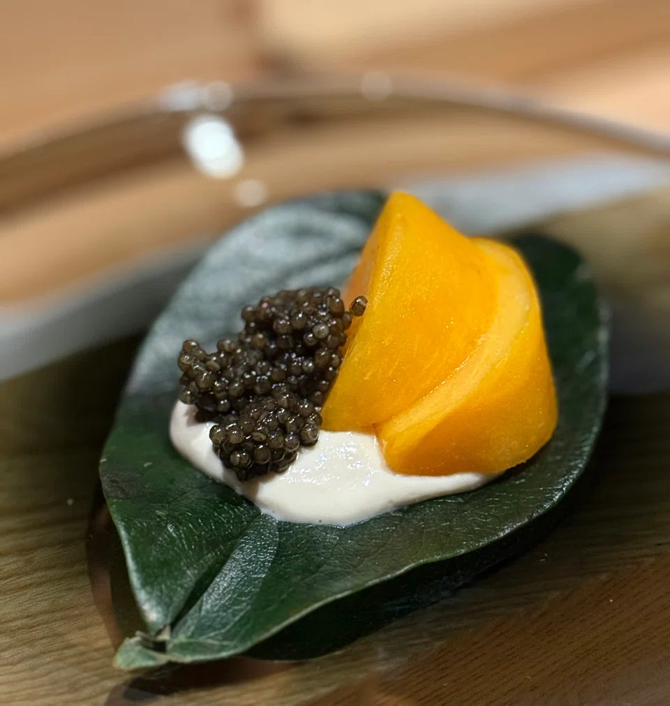 Persimmon with caviar and tofu cream.