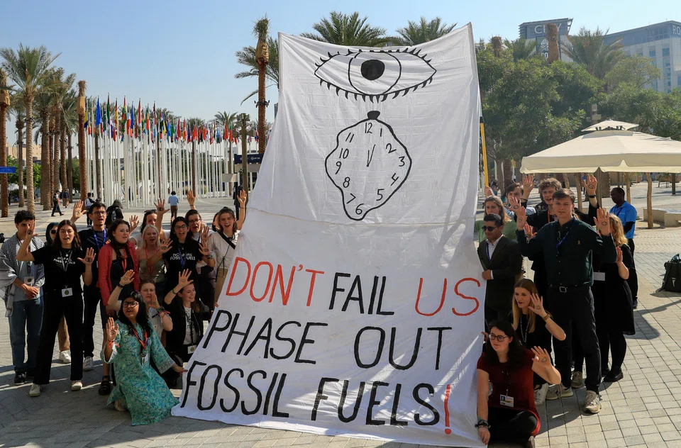 A protest against fossil fuels during the COP28 climate summit in Dubai, in December 2023. Phasing out fossil fuels is a good idea, but how to make it happen?  