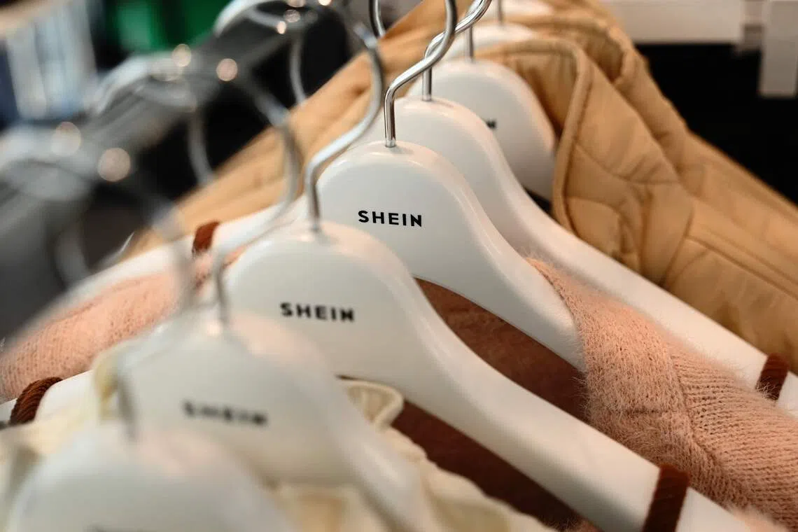 (FILES) This photo taken on November 10, 2022 shows the Shein logo on coat hangers during a media preview of the first permanent showroom of Chinese online fast fashion giant Shein in Tokyo. Shein annouced on October 1, 2025 that the brand is to open permanent stores in France, a world first. (Photo by Richard A. Brooks / AFP)
