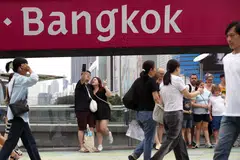 Foreign tourists take photographs at a shopping district in Bangkok, Thailand, Feb 24, 2025. 