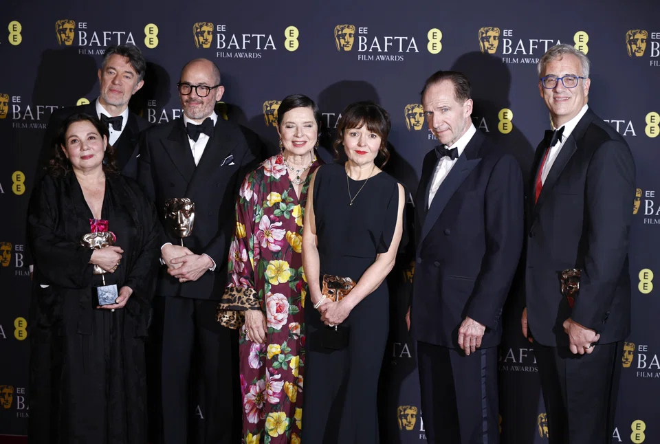 (From left) Tessa Ross, Peter Straughan, Edward Berger, Isabella Rossellini, Juliette Howell, Ralph Fiennes and Michael Jackman pose with the Best Film award for "Conclave" during the Bafta Film Awards at the Royal Festival Hall in London, Britain, on Feb 16, 2025.
