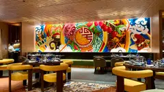 A huge, Chinese-inspired mural covers an entire wall in Quan Hotpot.