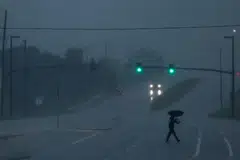 A man walks down an avenue as Hurricane Milton approaches, Orlando, Florida, Oct 9, 2024.  