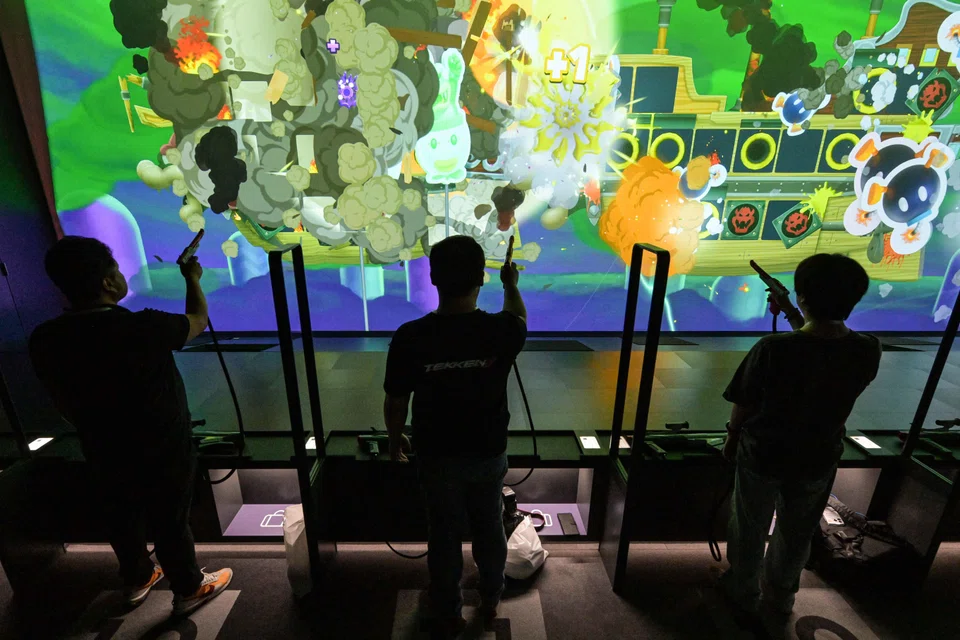 Visitors playing the shooting game "Zapper and Scope SP" at the new Nintendo Museum in Kyoto, Japan, Sept 24, 2024. 