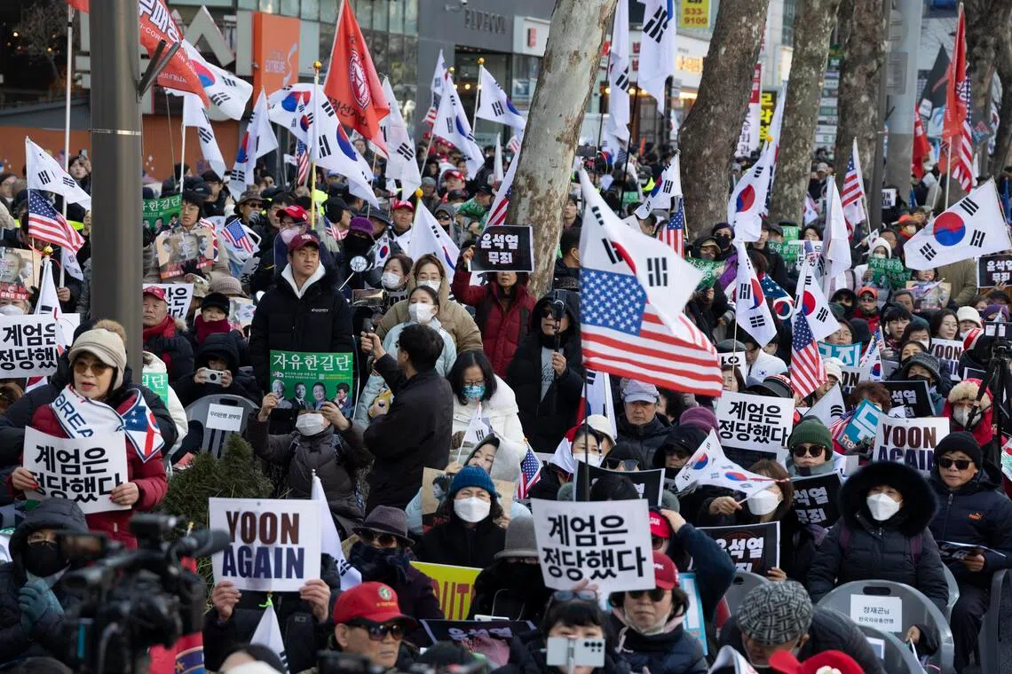 Supporters of former South Korean President Yoon Suk Yeol shout slogans as they rally outside the Seoul Central District Court in Seoul, South Korea, Feb 19, 2026. 