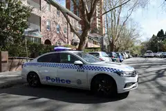 A police vehicle is parked on a closed street near the scene where a car crashed into the Russian consulate in Sydney, Australia, Sep 1, 2025.